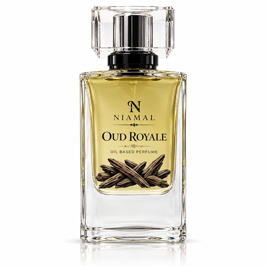 A clear glass rectangular perfume bottle filled with golden-yellow fragrance oil, featuring a black spray collar and a clear faceted cap. The front label reads 'NIAMAL OUD ROYALE OIL BASED PERFUME' with an illustration of dark brown cloves.